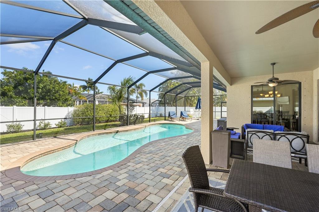 View of swimming pool featuring an outdoor lounge area, patio surround, a sunroom, a lanai, and a fenced backyard