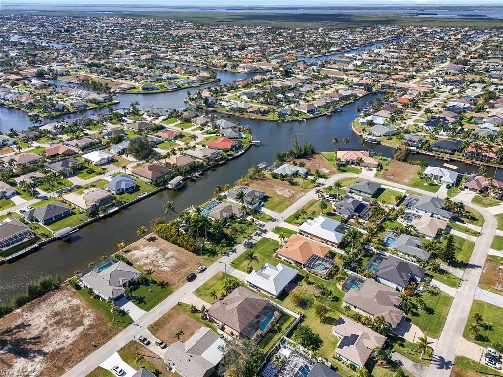 Aerial view of property's location featuring nearby suburban area and a nearby body of water