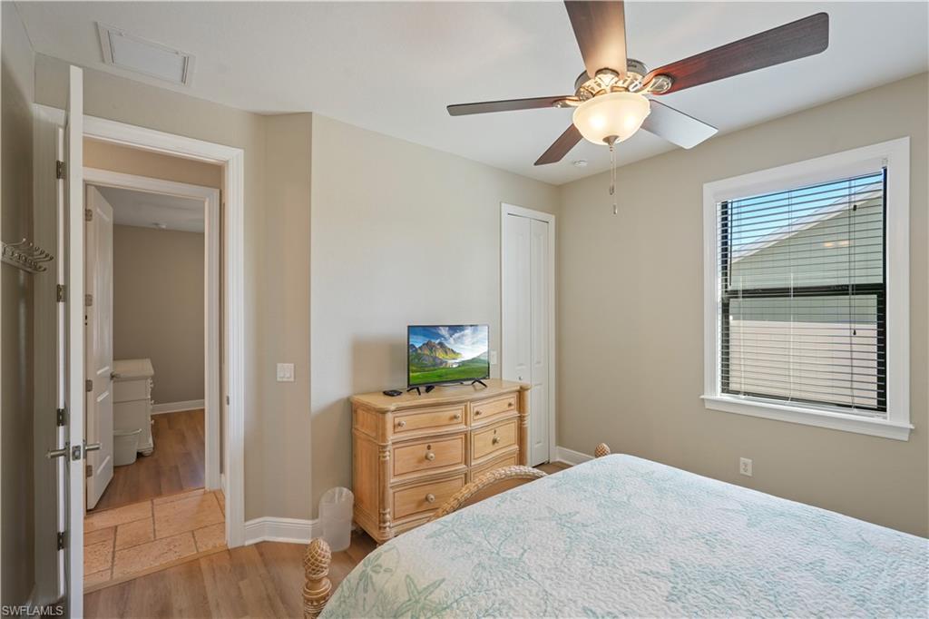 Bedroom featuring light wood finished floors, ceiling fan, and a closet