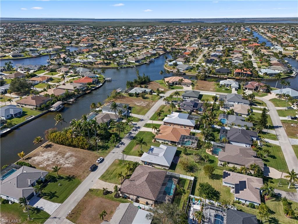 Aerial view of property's location featuring nearby suburban area and a nearby body of water