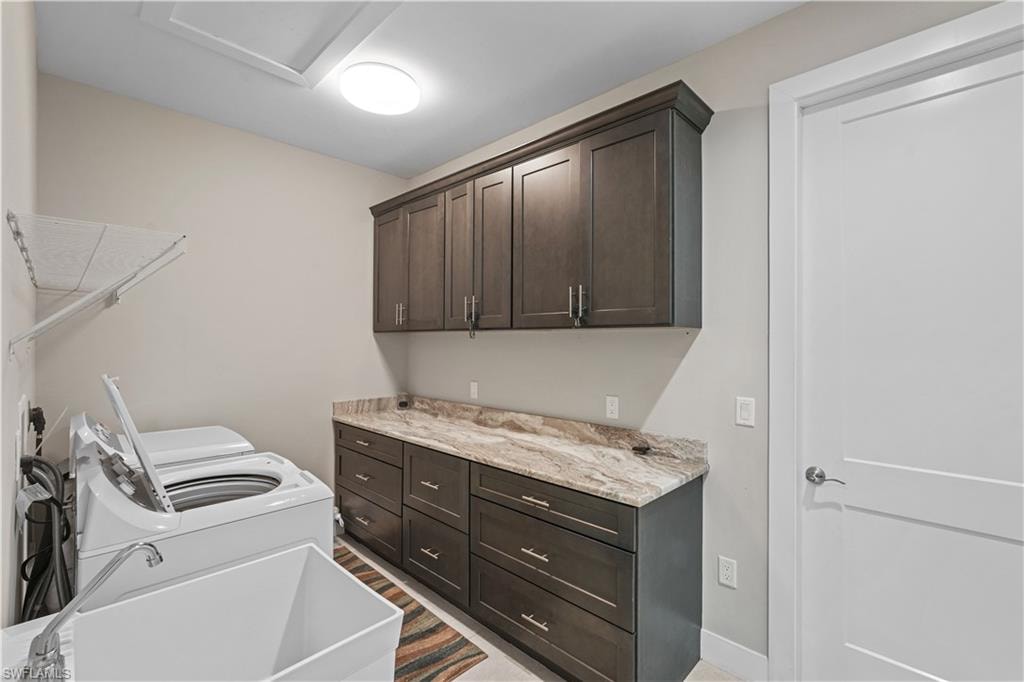 Laundry room featuring independent washer and dryer and cabinet space