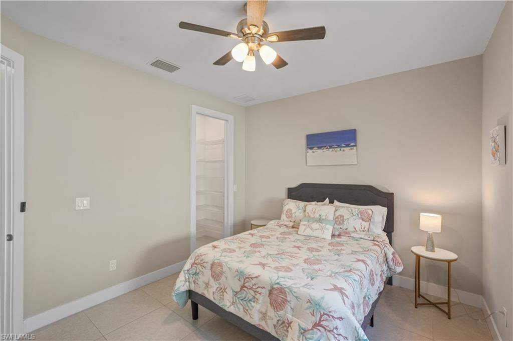 Bedroom featuring light tile patterned floors and ceiling fan