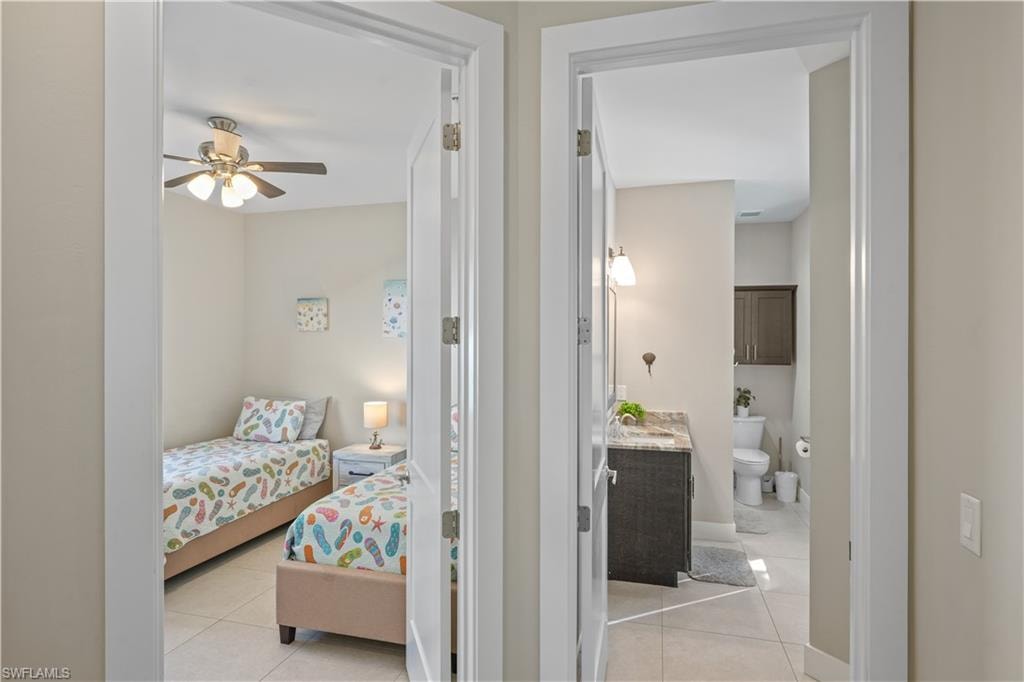 Bedroom featuring light tile patterned floors and ceiling fan