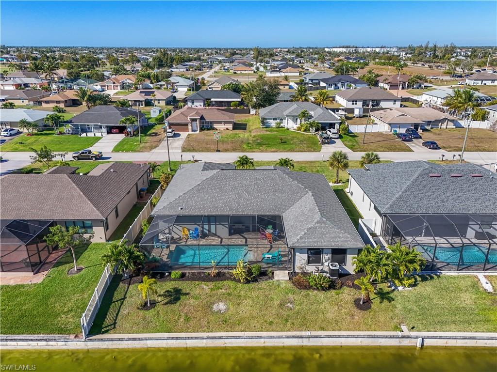 Aerial perspective of suburban area featuring a pool