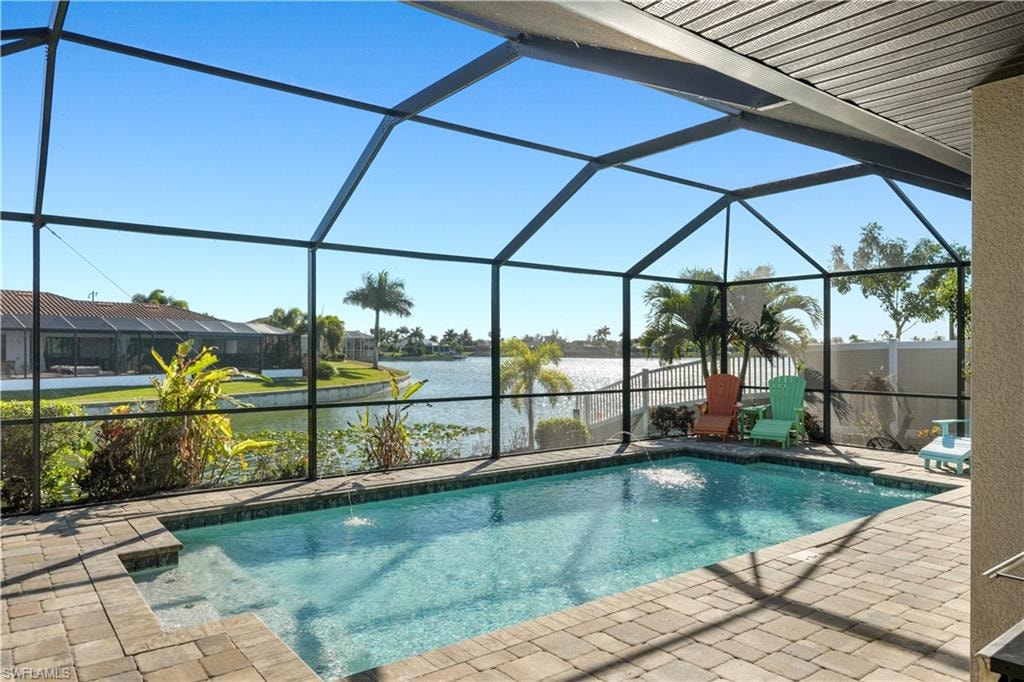 Swimming pool with a sunroom, a lanai, a water view, and a patio area