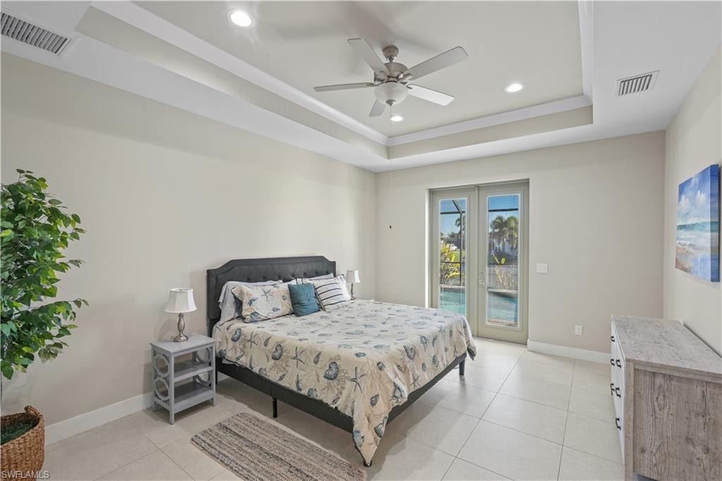 Bedroom with access to outside, recessed lighting, a ceiling fan, light tile patterned floors, and a raised ceiling