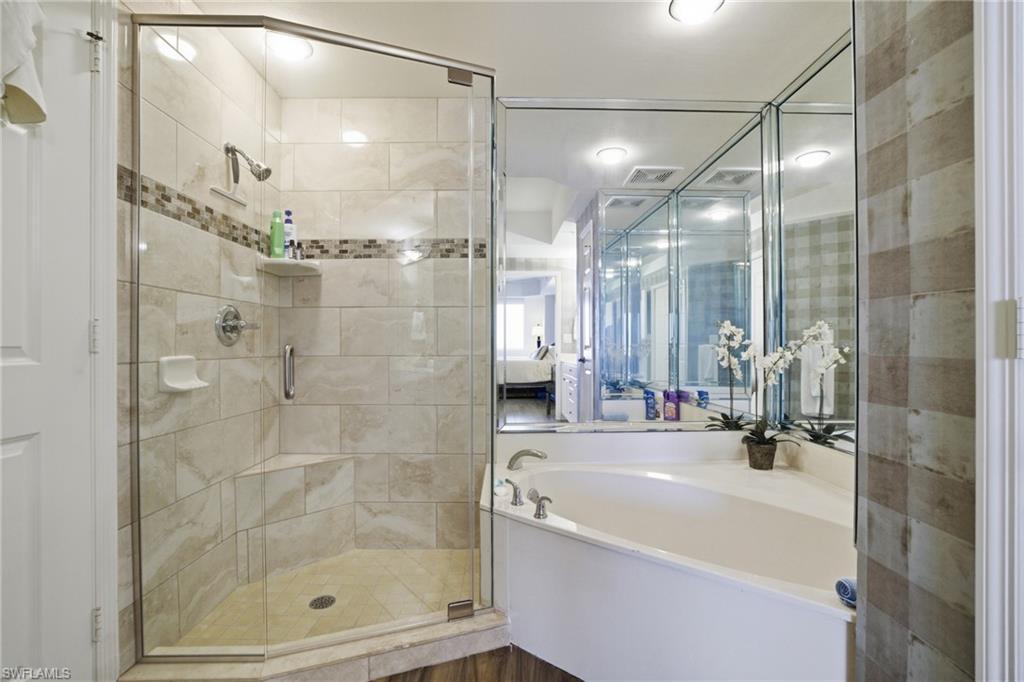 Bathroom featuring a garden tub and a stall shower