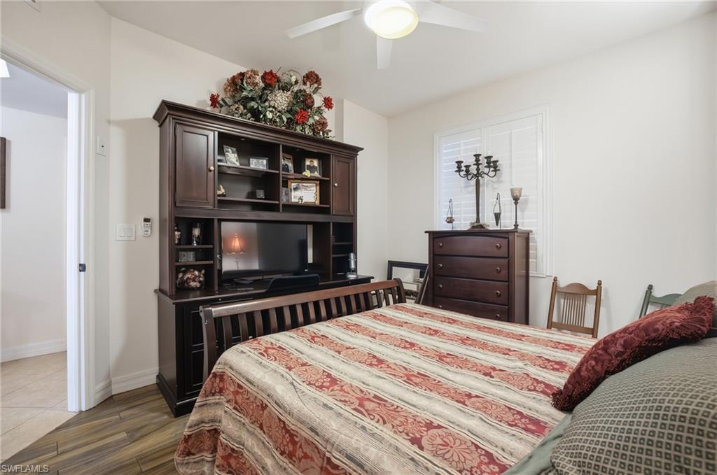 Bedroom with dark wood-type flooring and ceiling fan