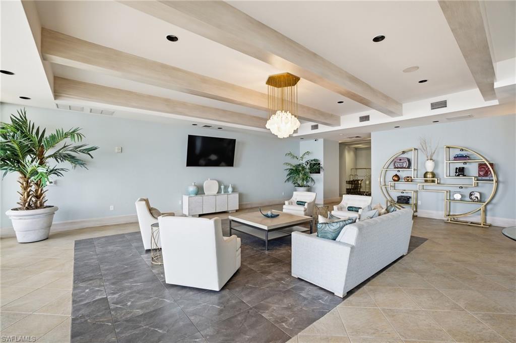 Living room featuring beamed ceiling, recessed lighting, and light tile patterned floors