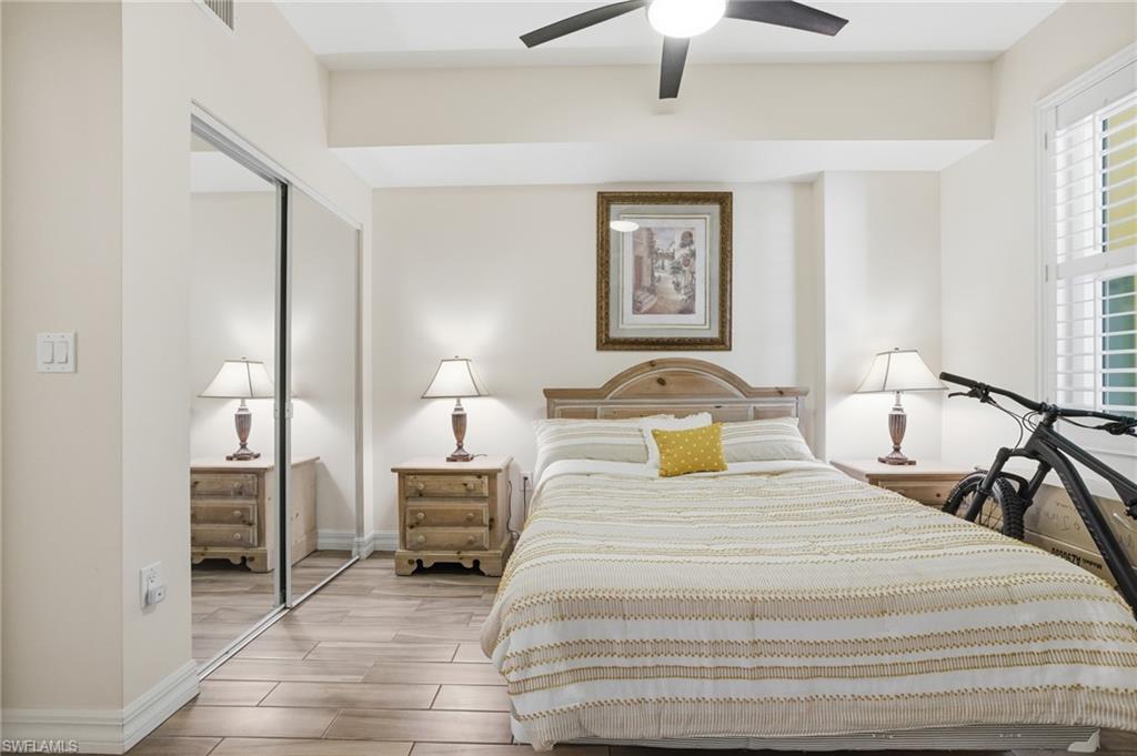 Bedroom with wood tiled floors, a closet, and a ceiling fan