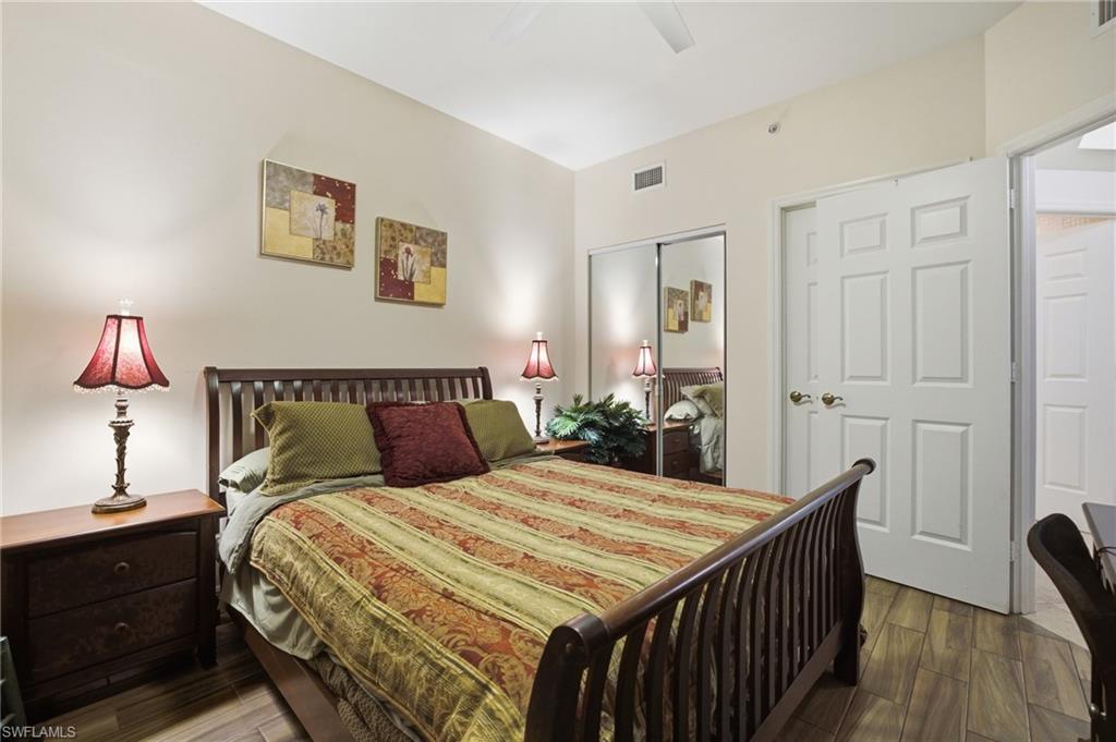 Bedroom featuring wood finish floors, a closet, and ceiling fan