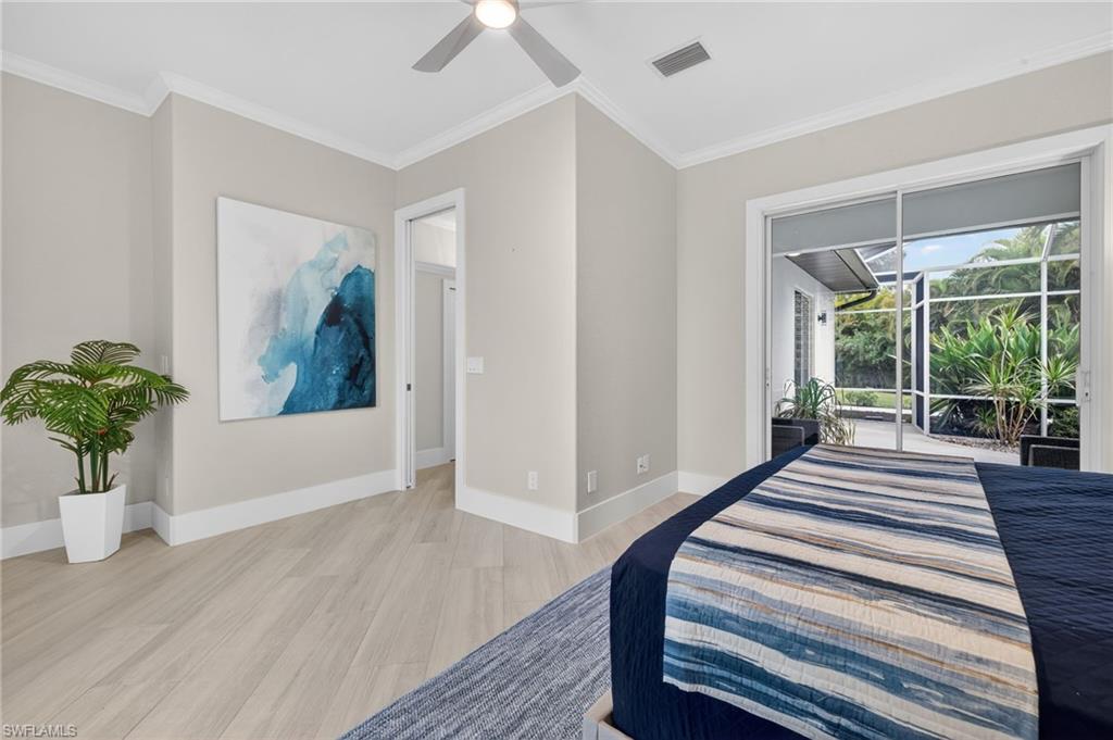 Bedroom with light wood-type flooring, access to exterior, ornamental molding, and a ceiling fan