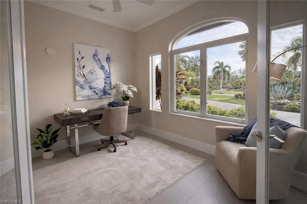 Office with ornamental molding and ceiling fan