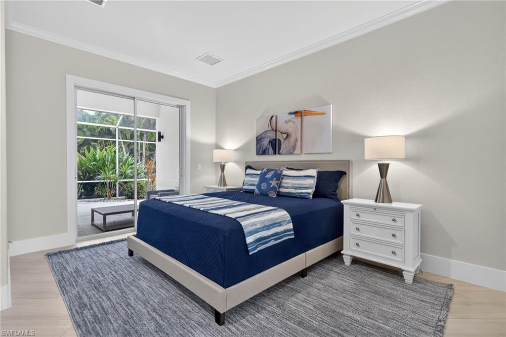 Bedroom with crown molding, access to exterior, and light wood finished floors