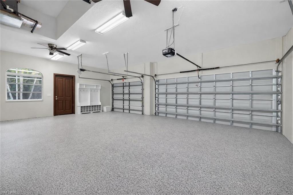 Garage with ceiling fan and a garage door opener