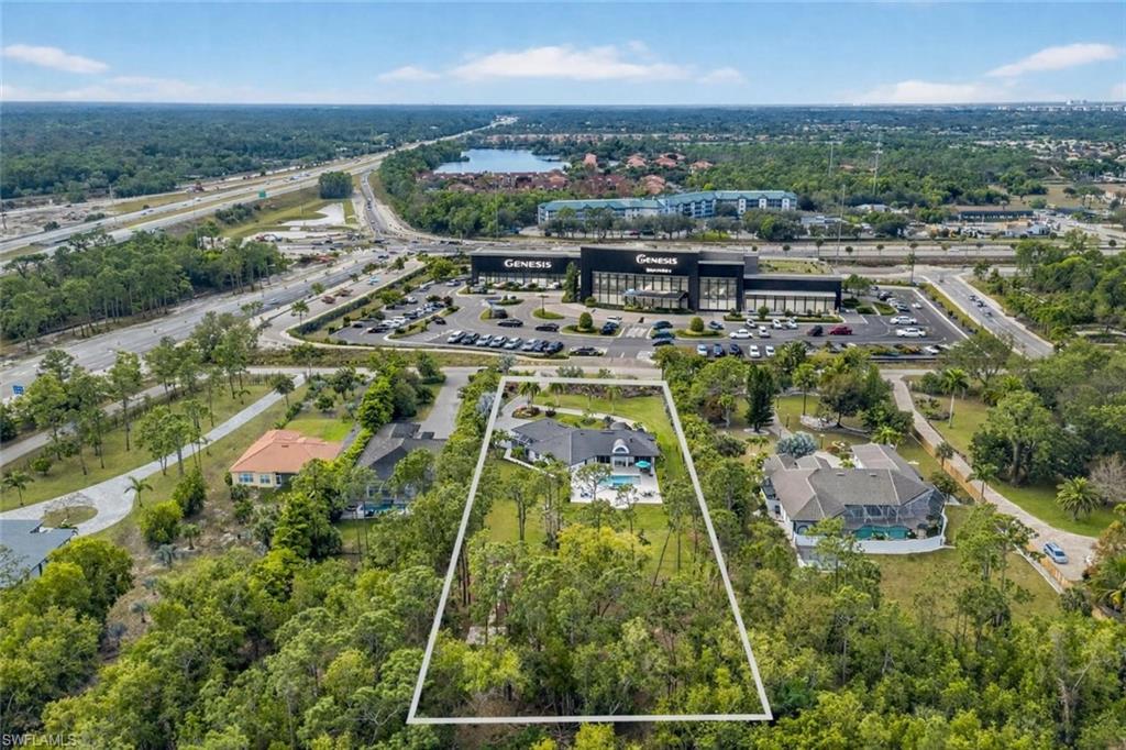 Aerial view of property's location with property parcel outlined and a large body of water