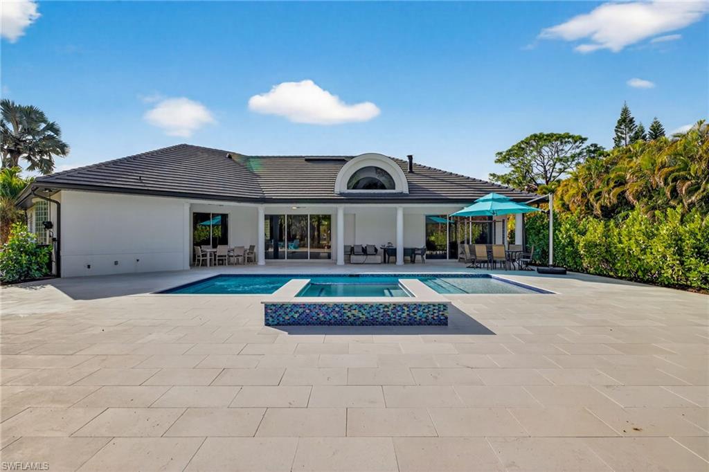Combined pool / hot tub featuring outdoor lounge area and a patio area