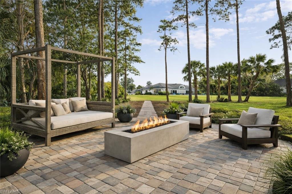 View of patio featuring an outdoor living space with a fire pit