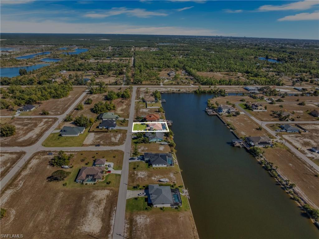 View of property location with a large body of water and nearby suburban area