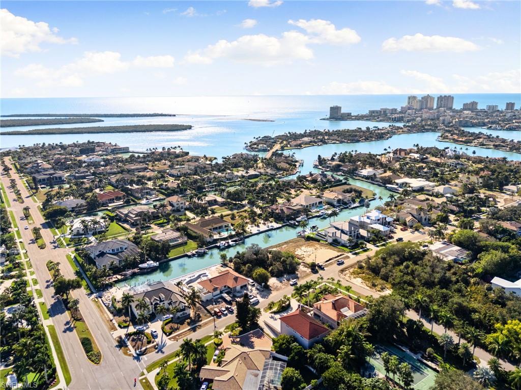 Aerial view of property's location with nearby suburban area and a nearby body of water