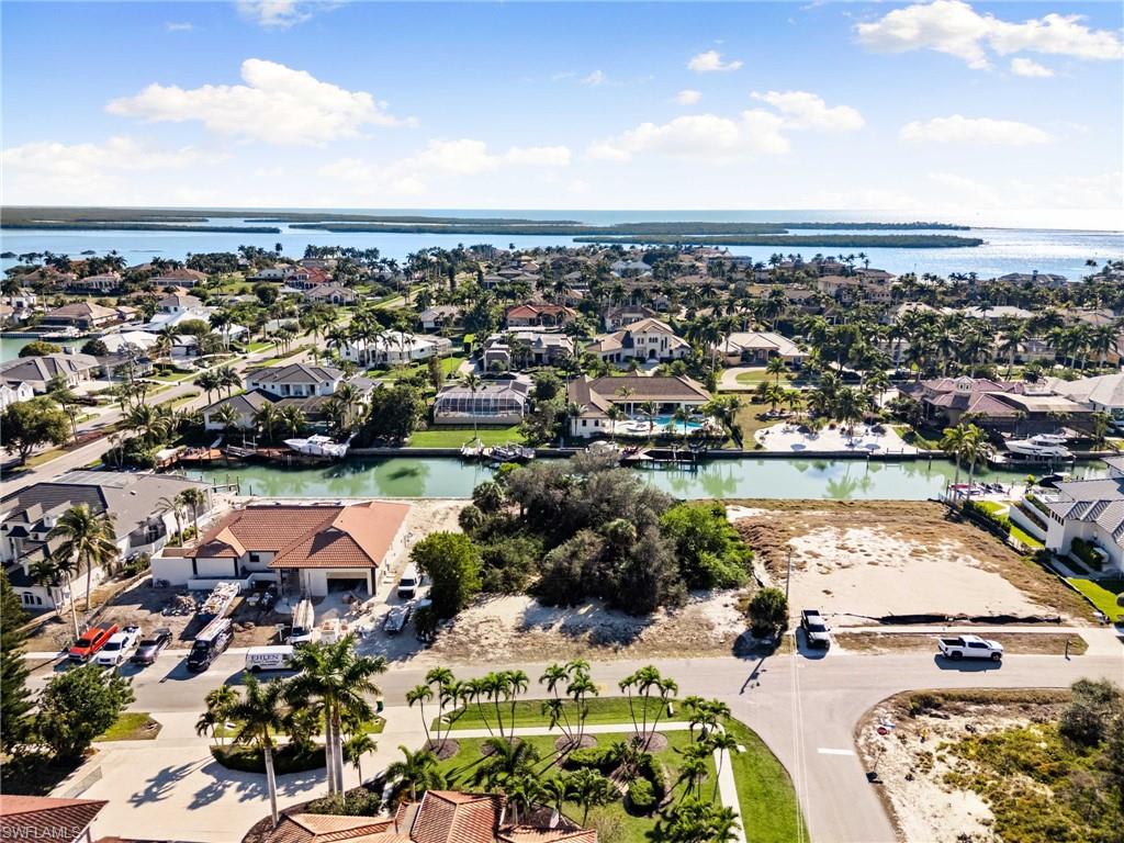Aerial view of property's location with nearby suburban area and a nearby body of water