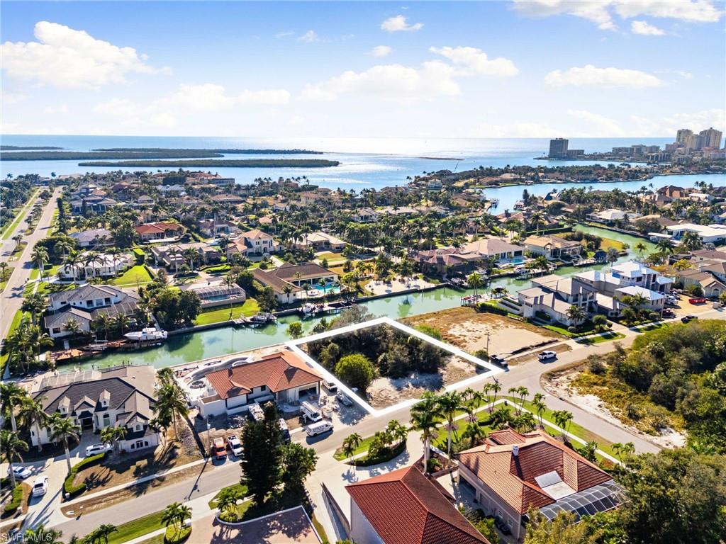 Aerial view of property's location with nearby suburban area and a large body of water