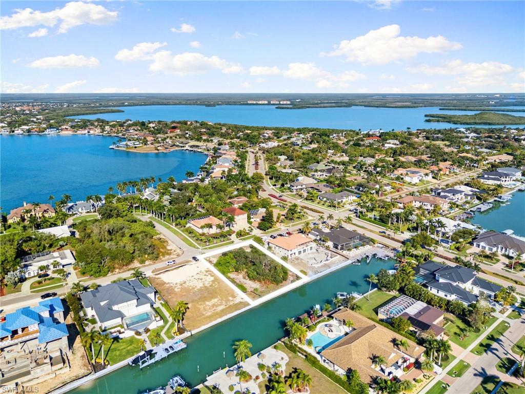 Aerial perspective of suburban area with a nearby body of water