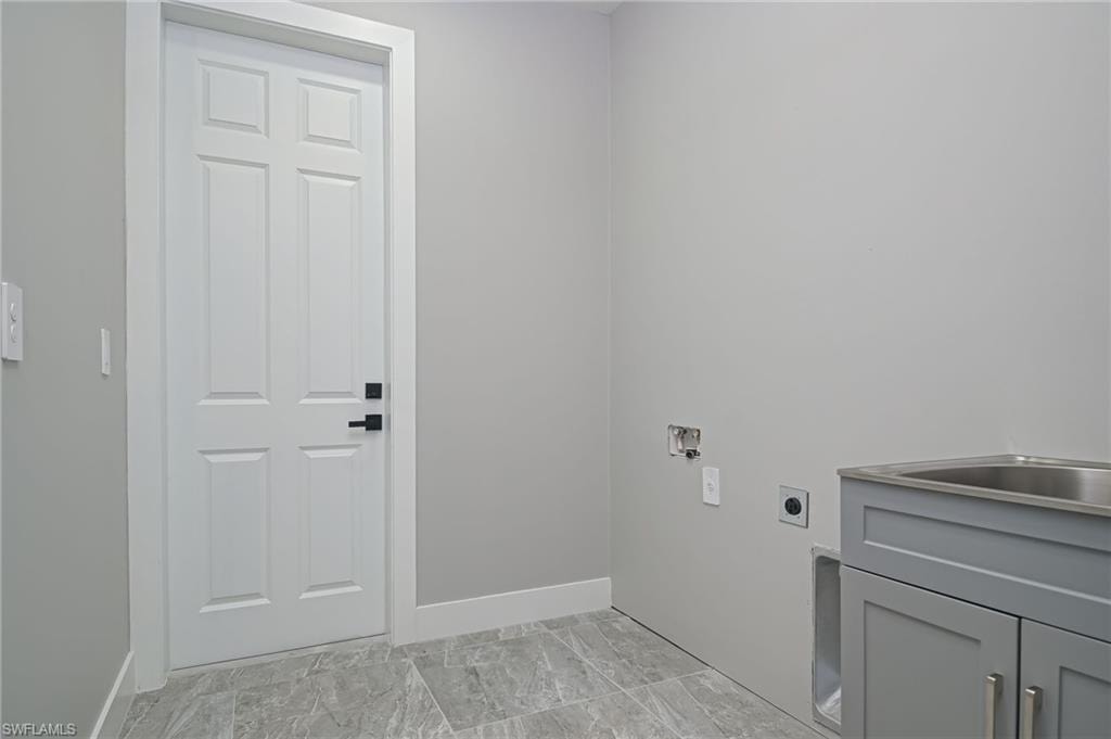 Laundry room with electric dryer hookup, cabinet space, and hookup for a washing machine