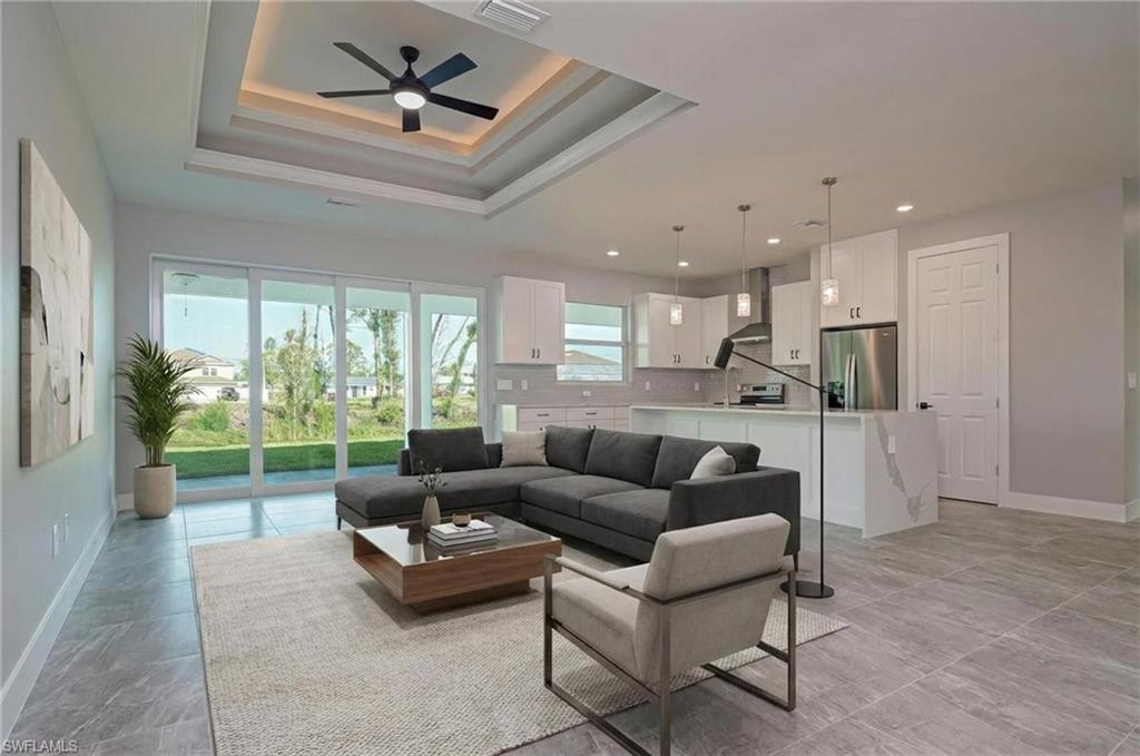 Living room with a ceiling fan and recessed lighting