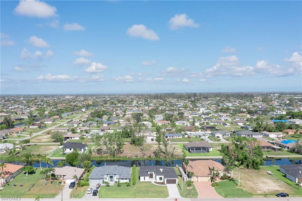 Aerial perspective of suburban area with a nearby body of water