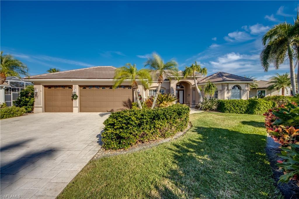 Mediterranean / spanish house featuring stucco siding, a front lawn, concrete driveway, and a tiled roof