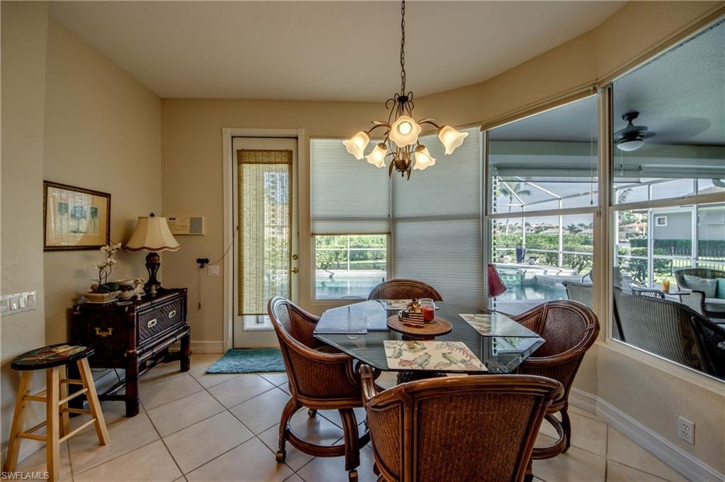 Dining space featuring light tile patterned floors, a ceiling fan, and hanging lights
