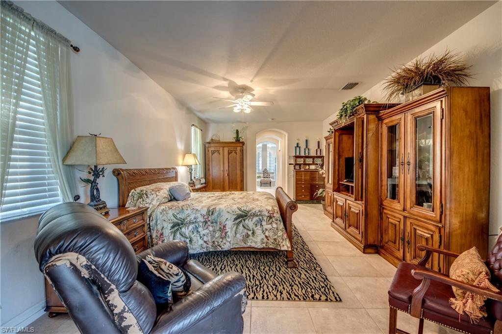 Bedroom featuring light tile patterned floors and a ceiling fan