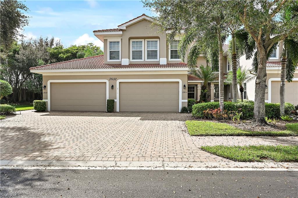 Mediterranean / spanish house with decorative driveway, a tile roof, stucco siding, and an attached garage
