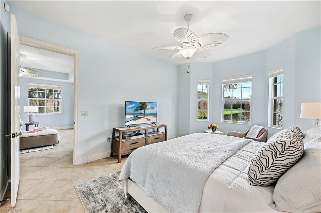 Bedroom with a ceiling fan and light tile patterned floors