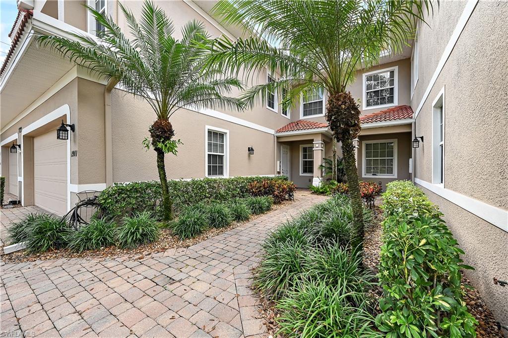 View of front of house featuring stucco siding, driveway, and an attached garage