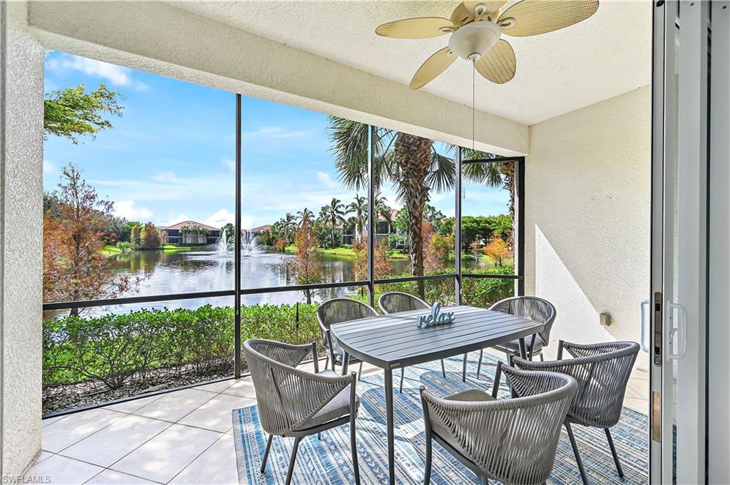 Sunroom / solarium featuring a water view, outdoor dining area, ceiling fan, and a balcony