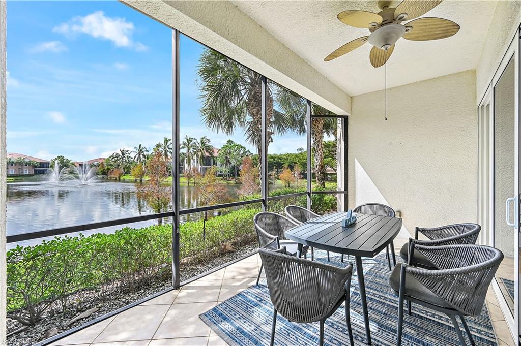 Sunroom / solarium with outdoor dining area, a water view, and a ceiling fan