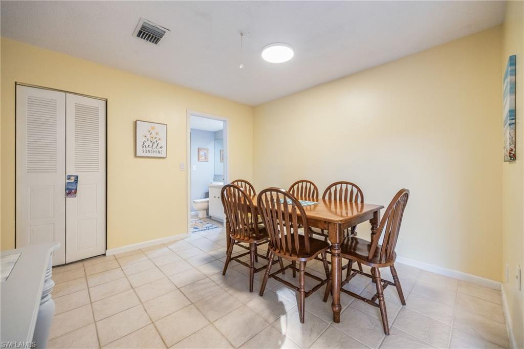Dining room with light tile patterned flooring and baseboards