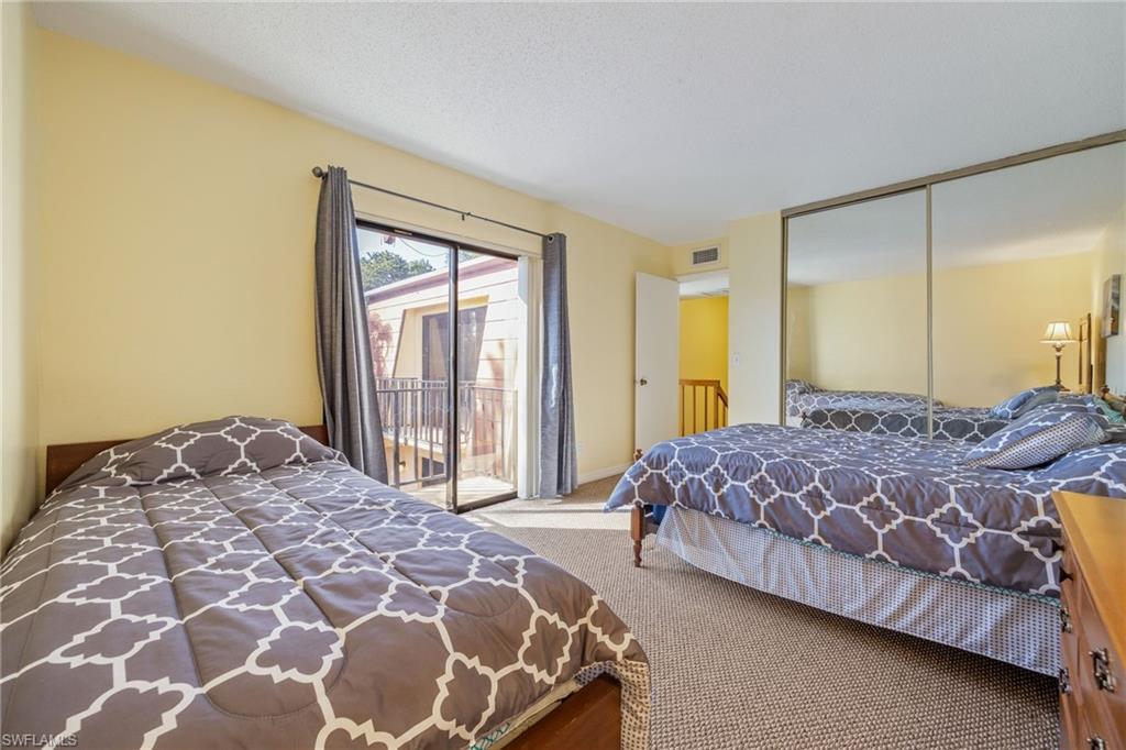 Bedroom featuring access to outside, carpet flooring, and a closet