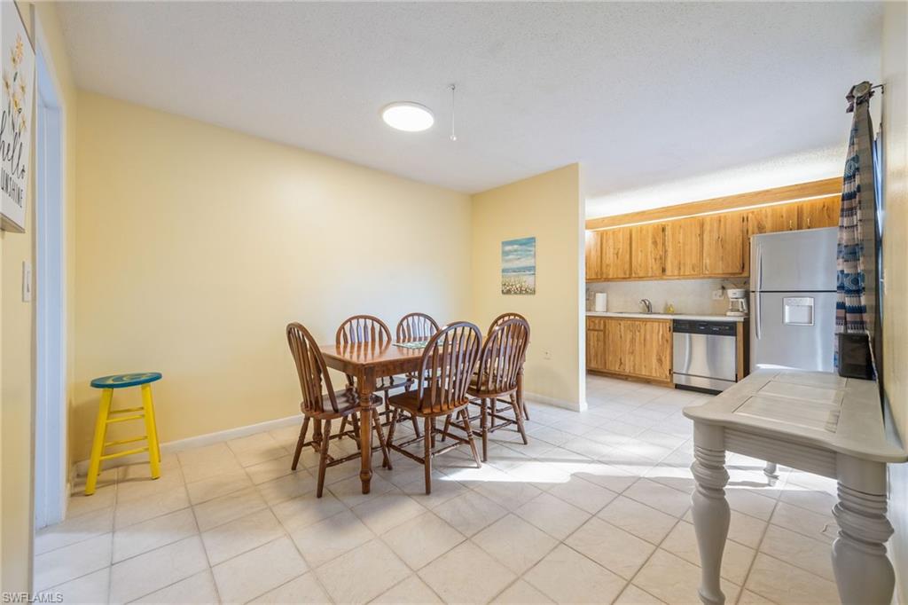 Dining area with baseboards and light tile patterned floors