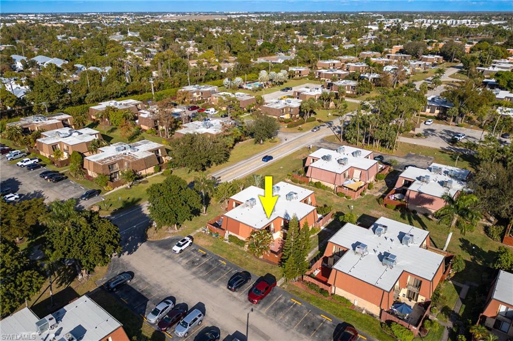 Aerial view of property and surrounding area featuring nearby suburban area