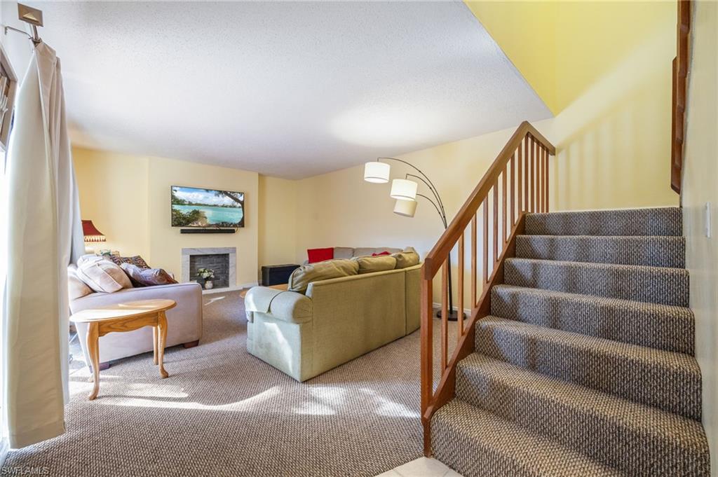 Living area featuring a fireplace and carpet