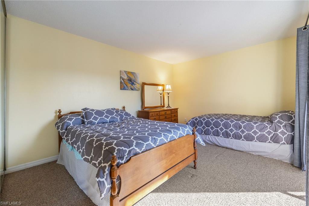 Carpeted bedroom with baseboards