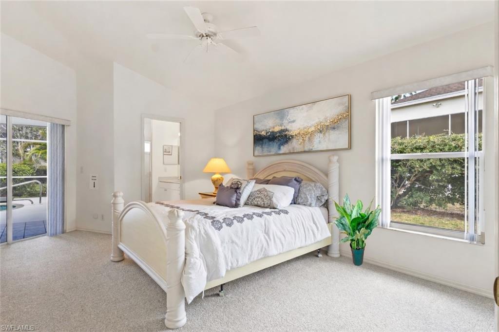 Carpeted bedroom featuring access to outside, ceiling fan, and lofted ceiling