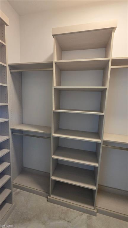 Built-in shelving and hanging rods in a light wood-finish
