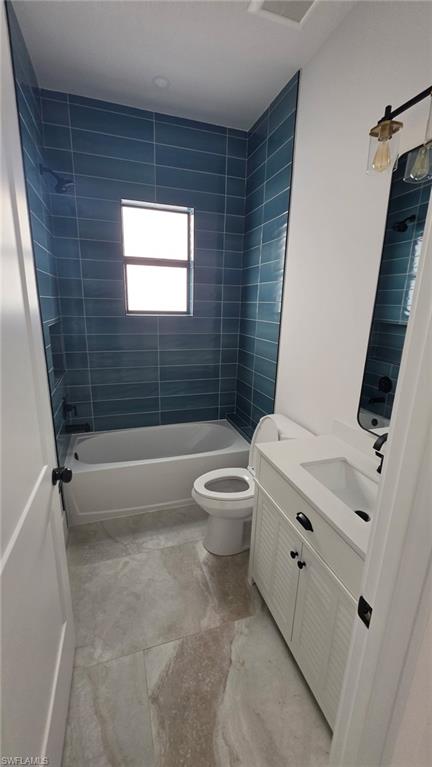 Full bathroom featuring a white vanity with white countertop, integrated sink, and dark hardware