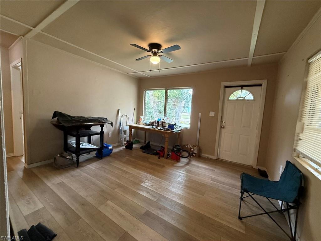 Foyer entrance with light wood-style floors and a ceiling fan