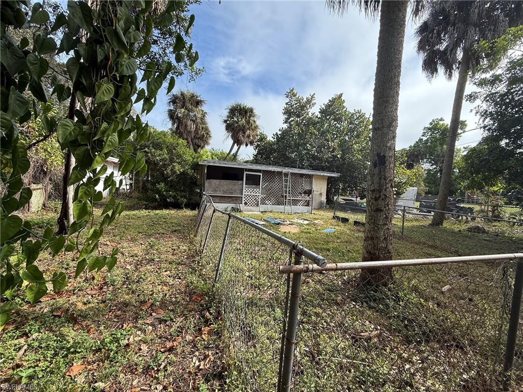 View of front of home with an outbuilding and a sunroom