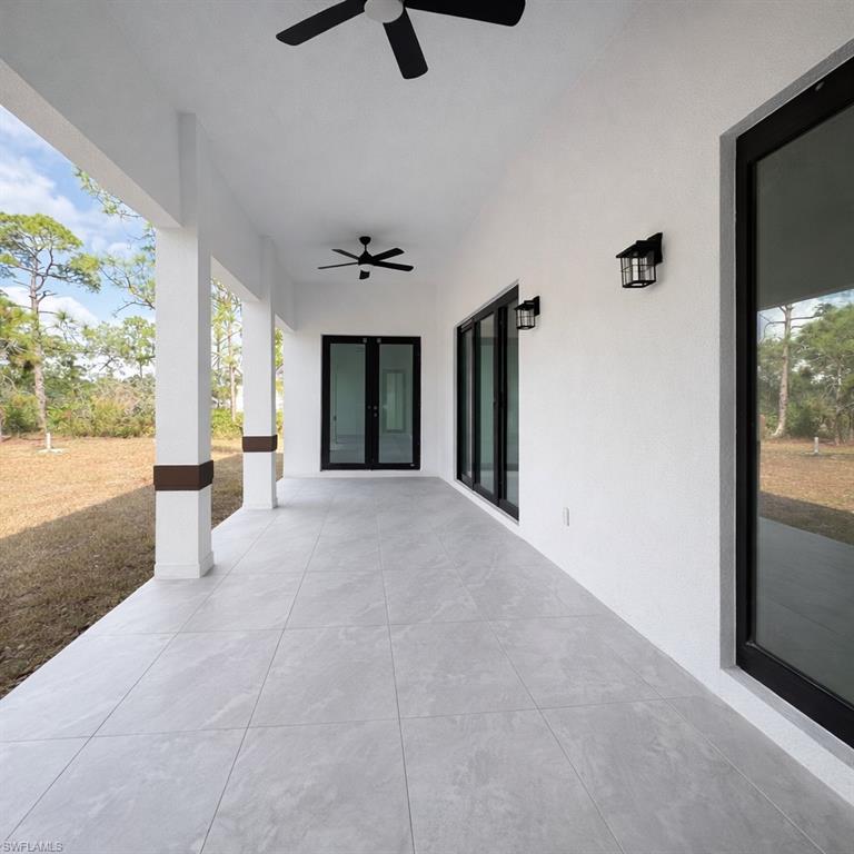View of patio with a ceiling fan and french doors